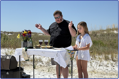 Rev. Forbes Sirmon and helper at beach church service