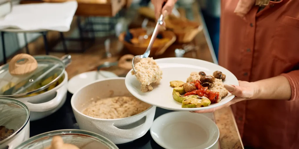 woman serving plate of food